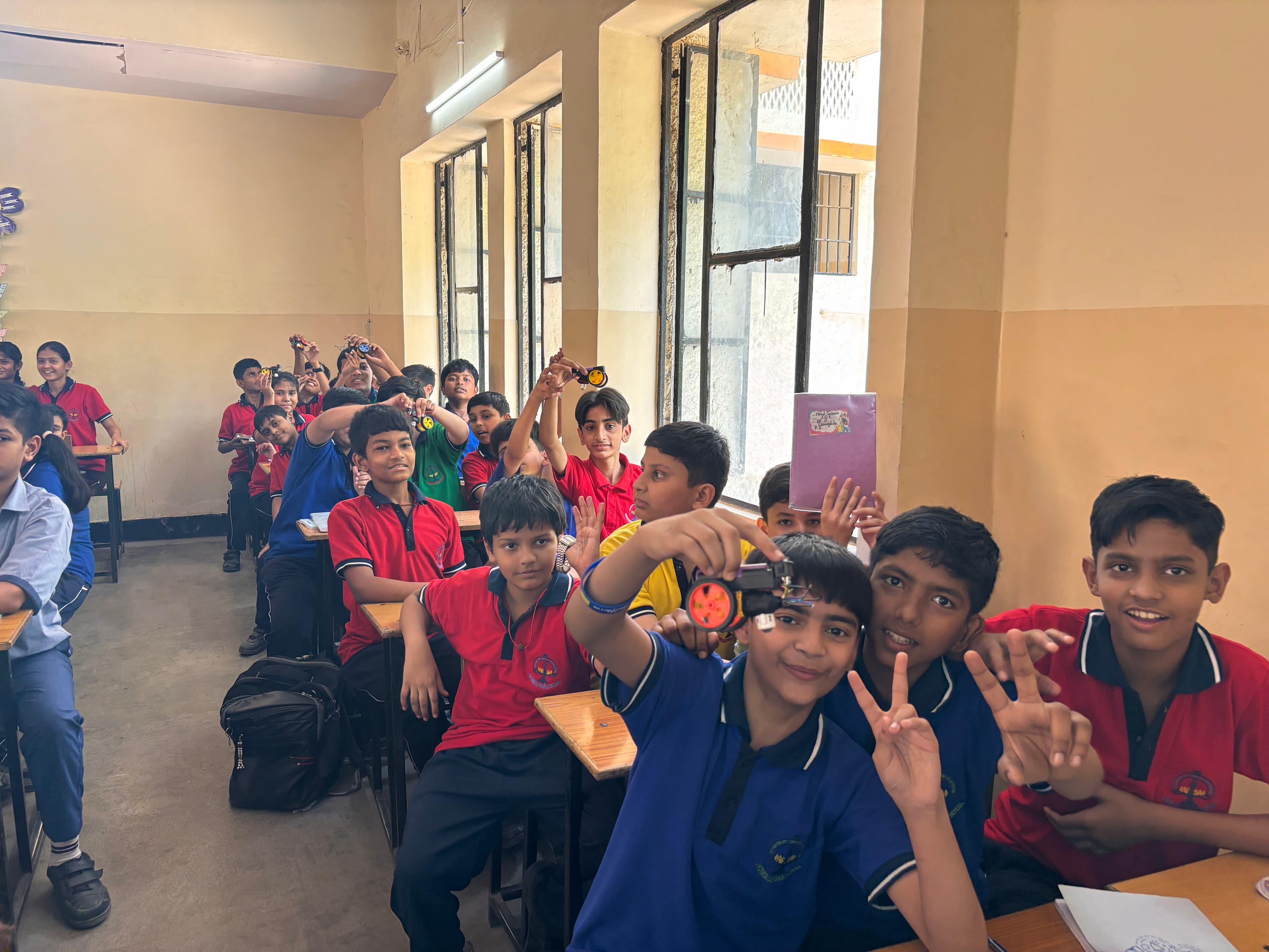 A student showing their hands-on learning kit