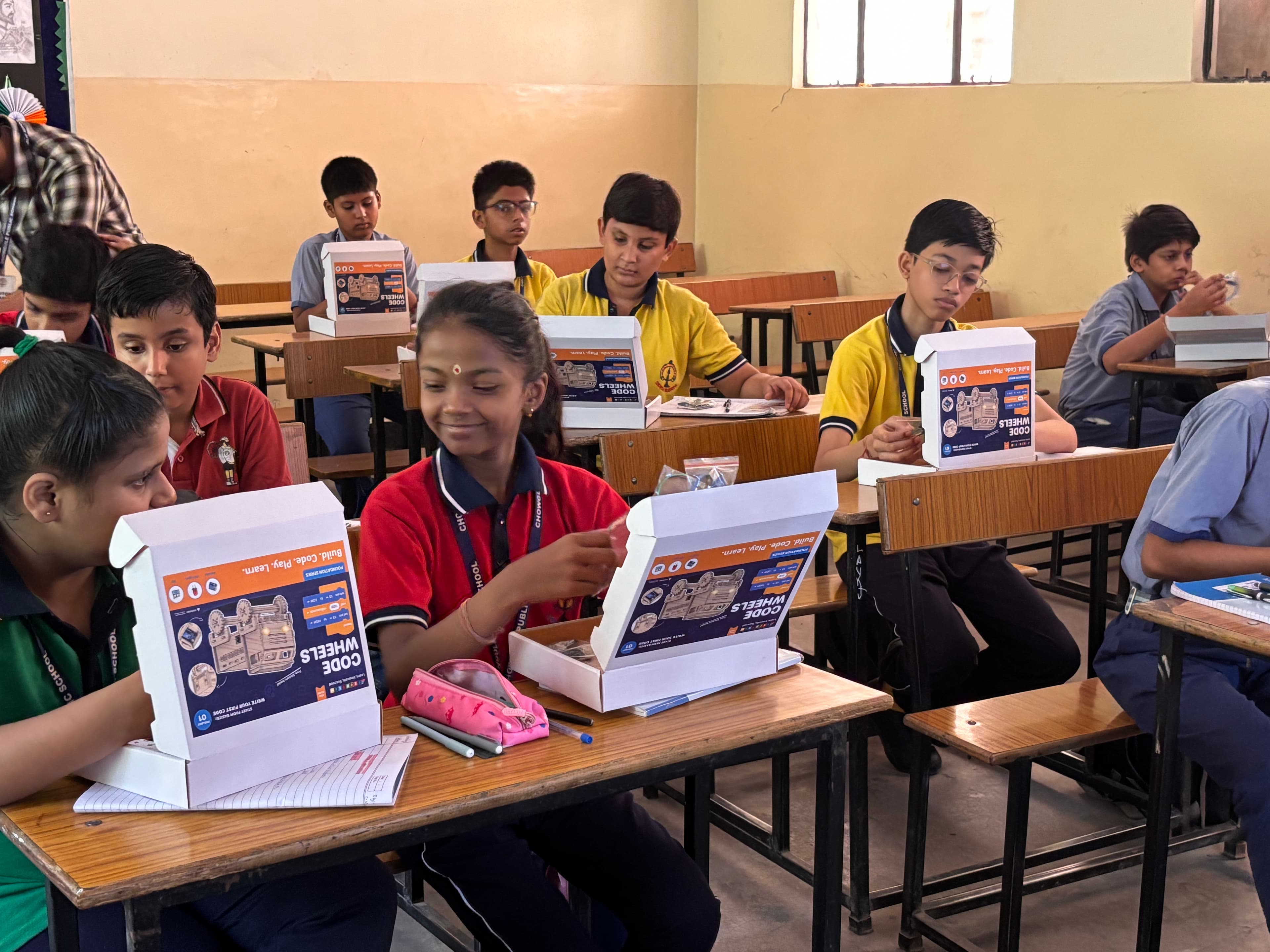 A student opening a hands-on learning kit