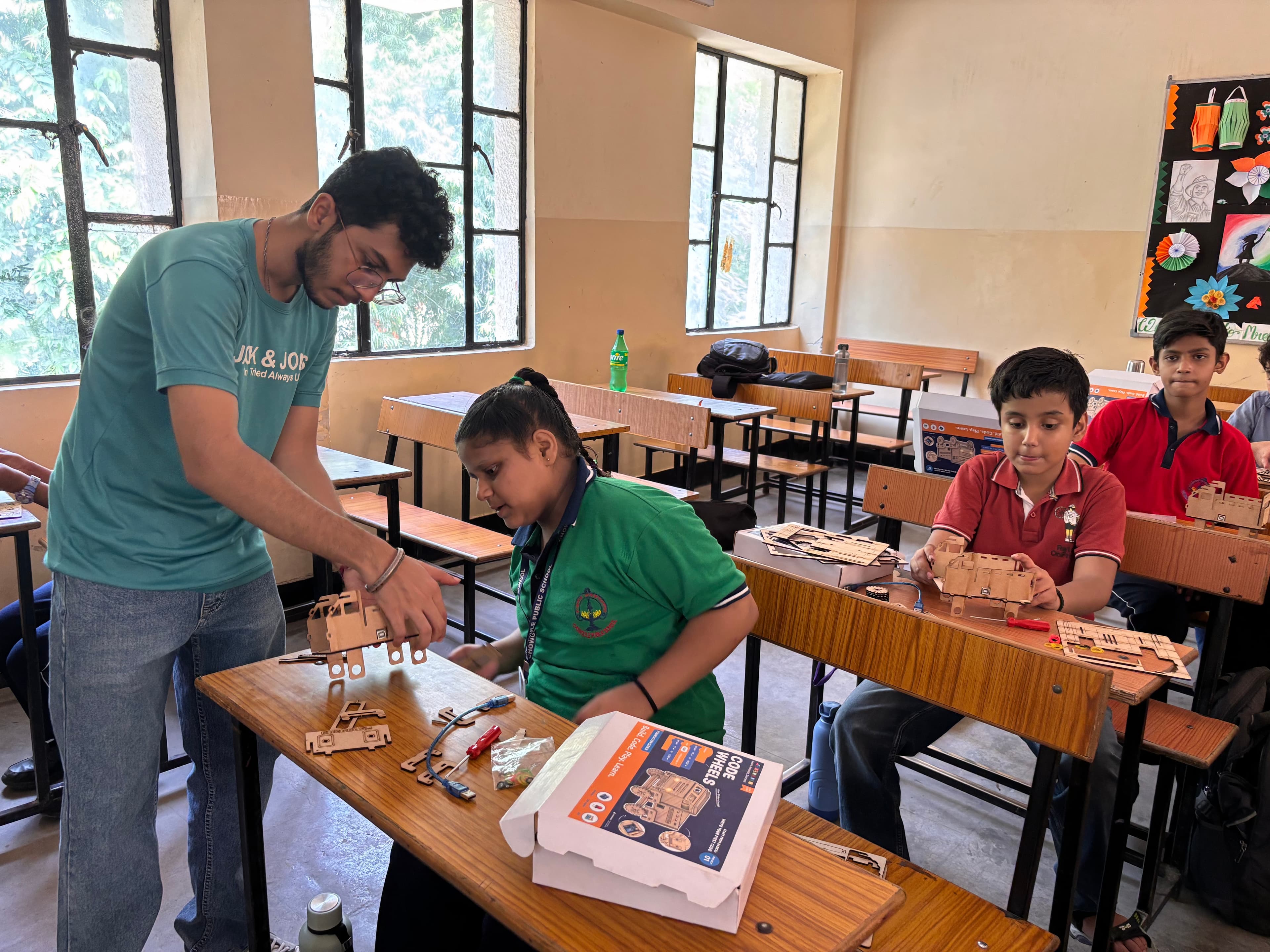 A teacher guiding students as they explore a learning kit